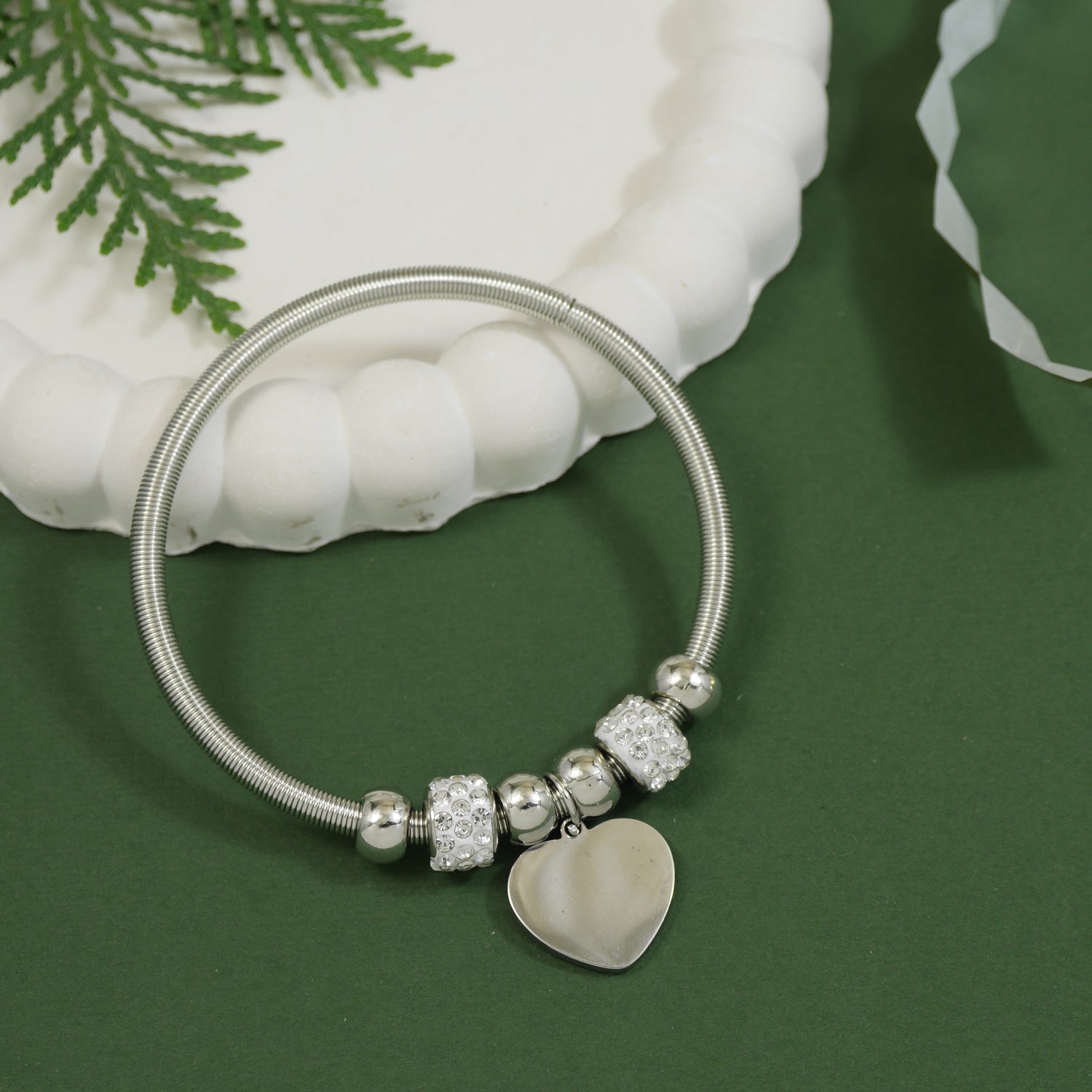 Dainty silver bracelet with crystal charms and a dangling heart pendant