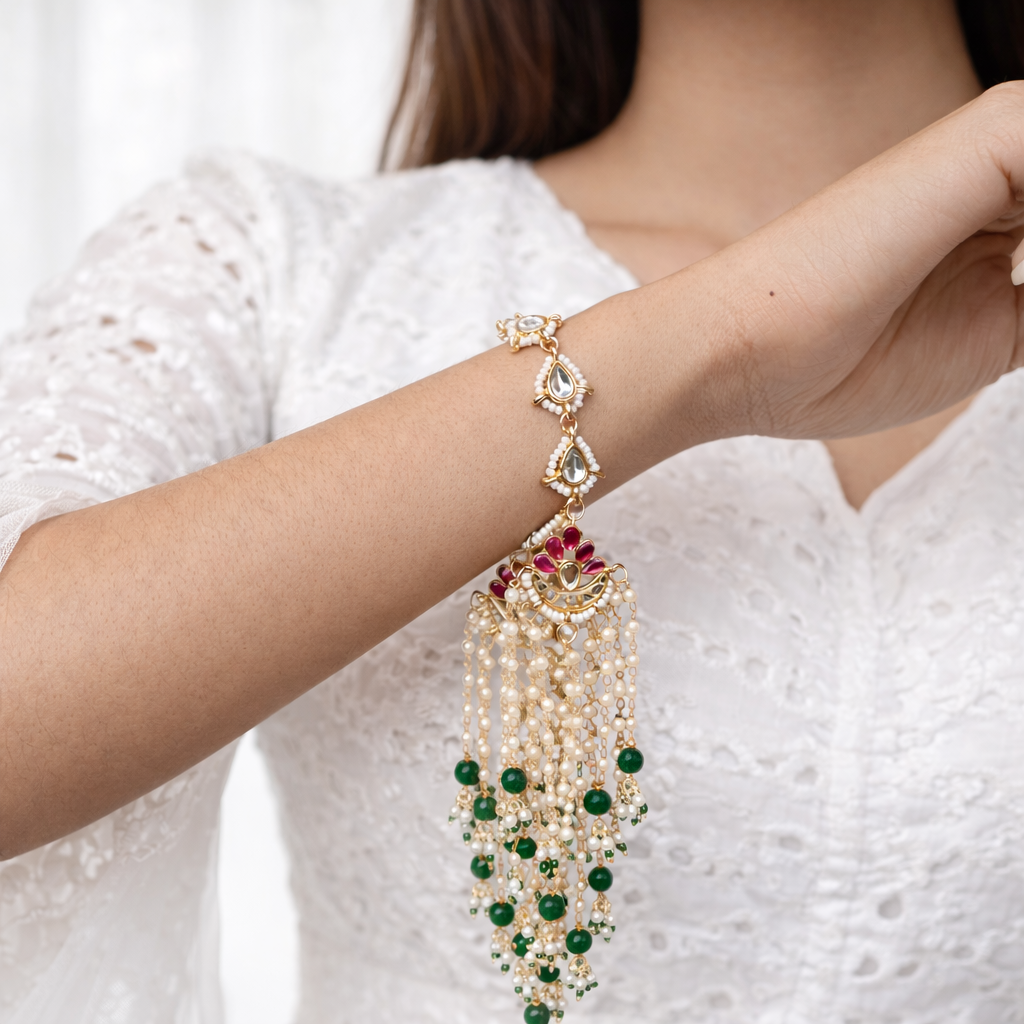 Jasleen- Kundan Pearl Tassel Statement Bracelet with Emerald Beads