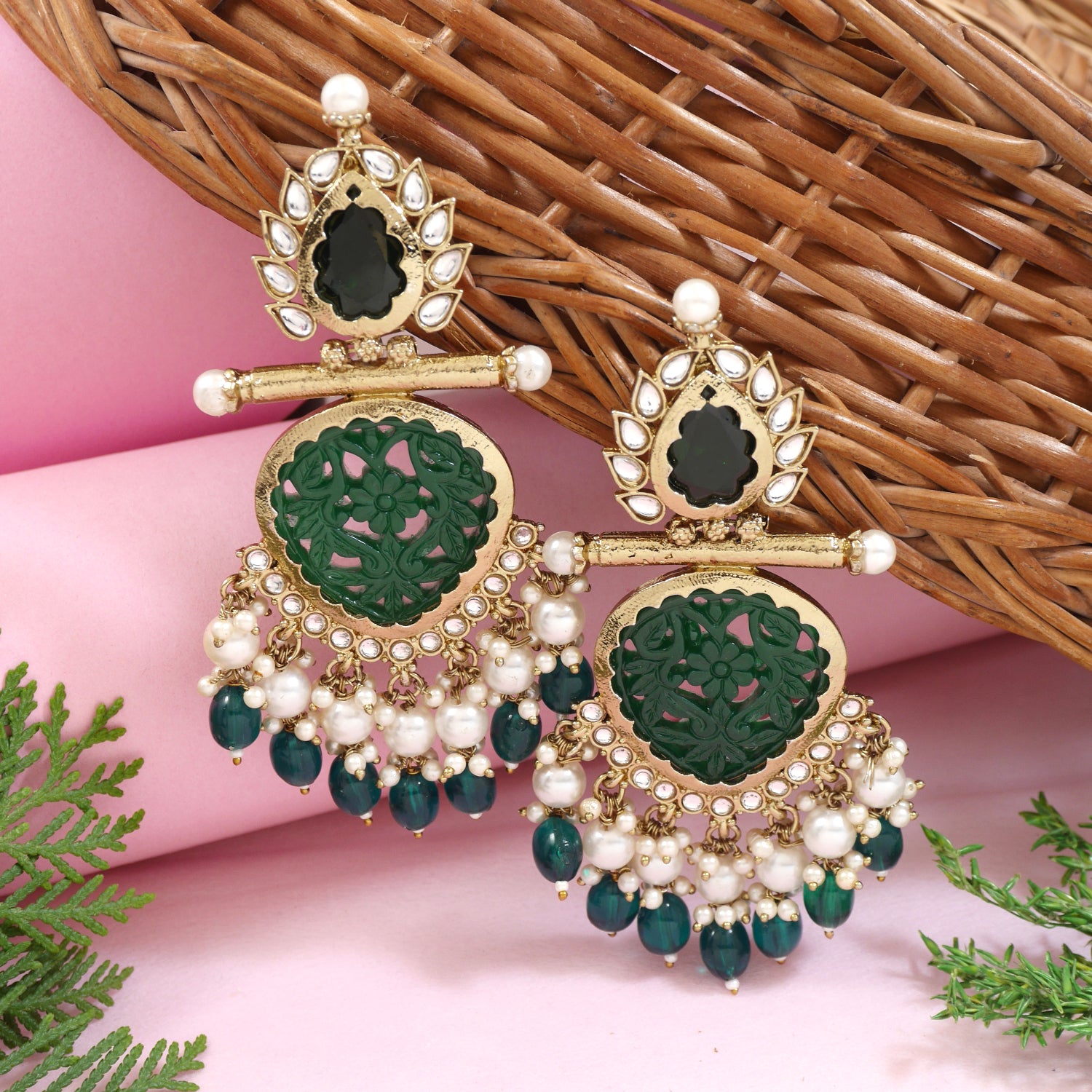 Antique gold-plated green kundan jhumka earrings with pearl drops and floral carving
