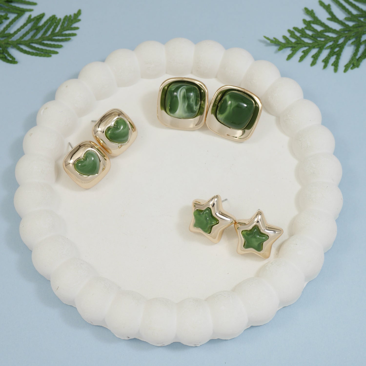 Emerald earring set with green enamel heart, star, and square-shaped gold-toned stud earrings