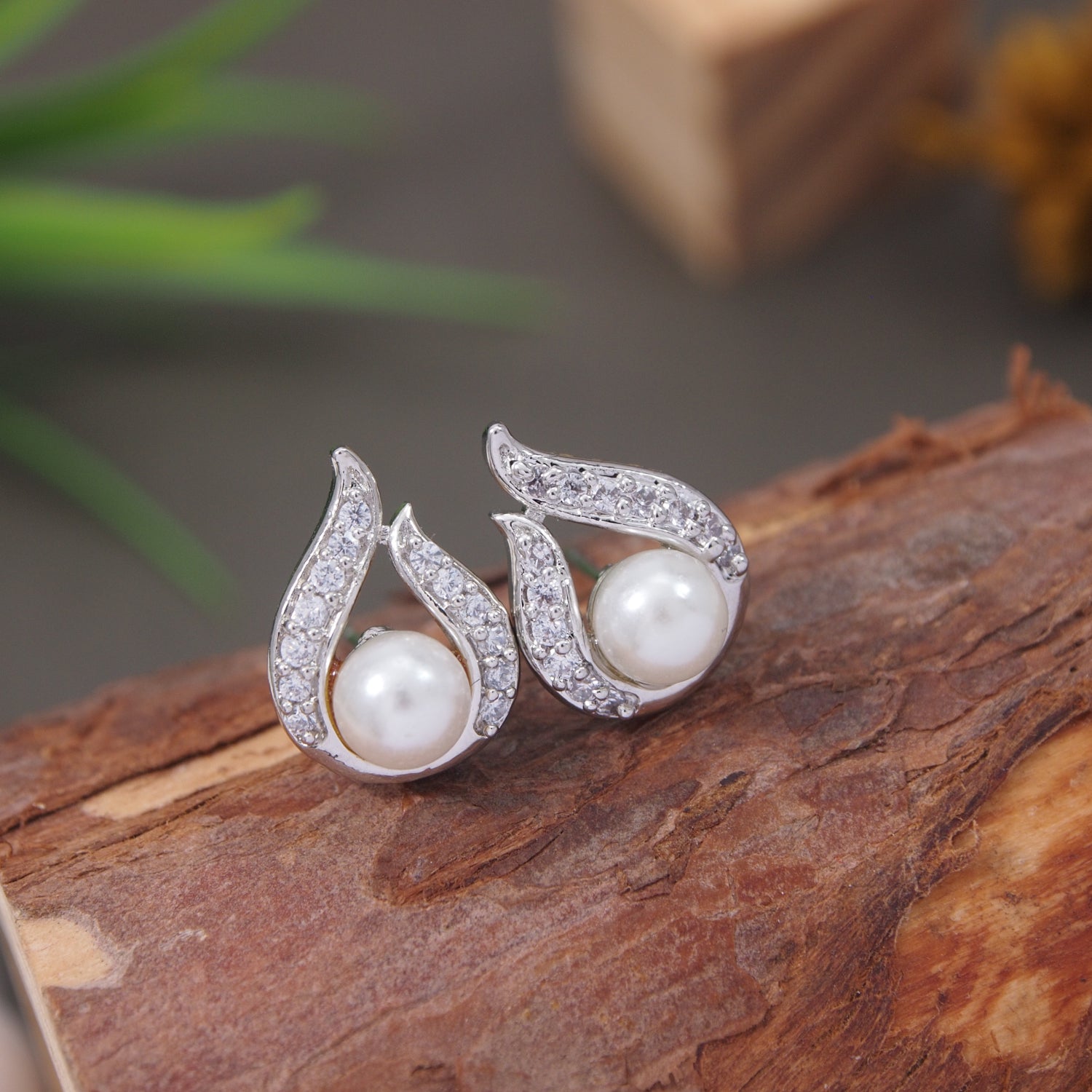 Silver stud earrings with pearl and crystal swirl design