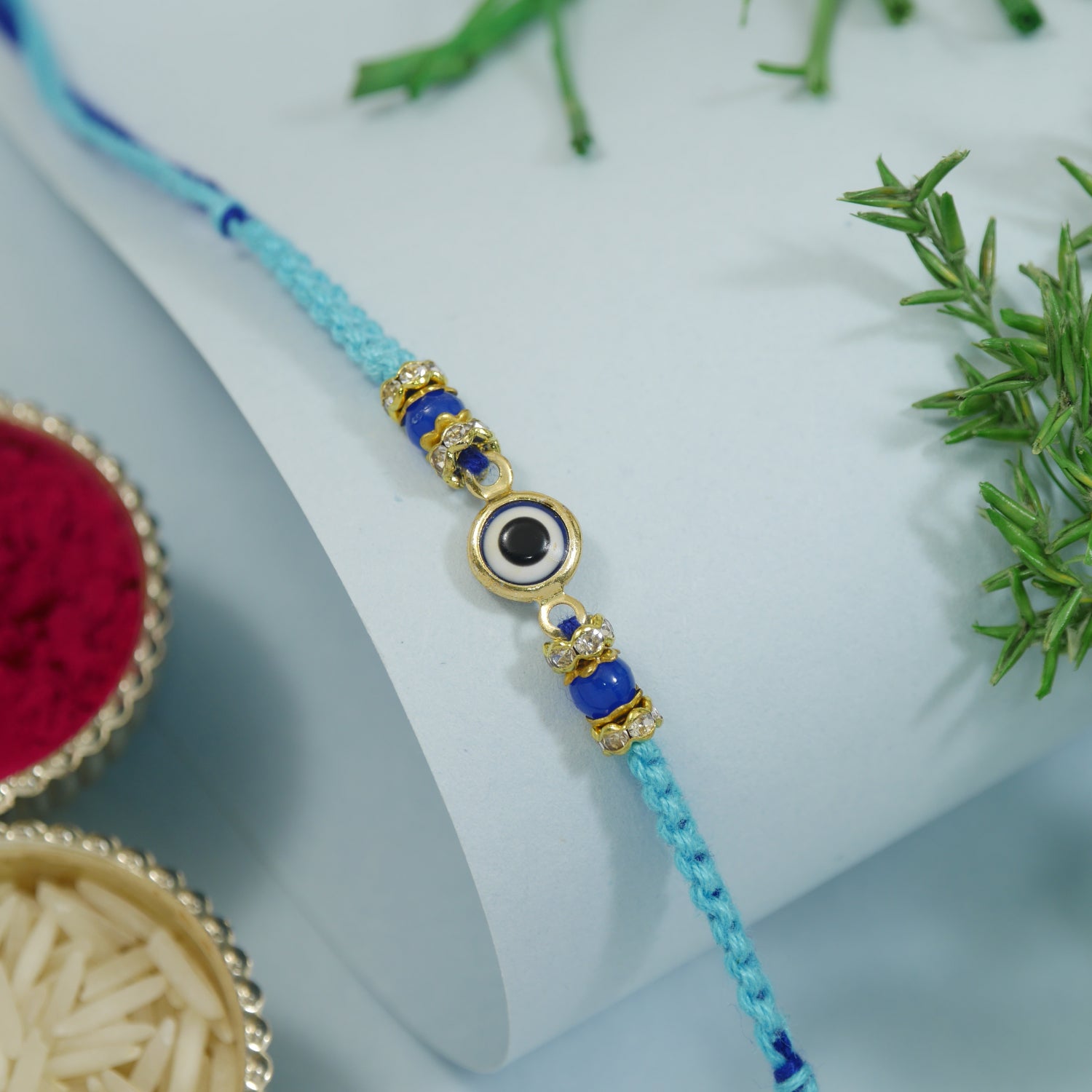 Minimalist Evil Eye Rakhis With Roli Chawal & Rakshabandhan Card (Pack of 2)