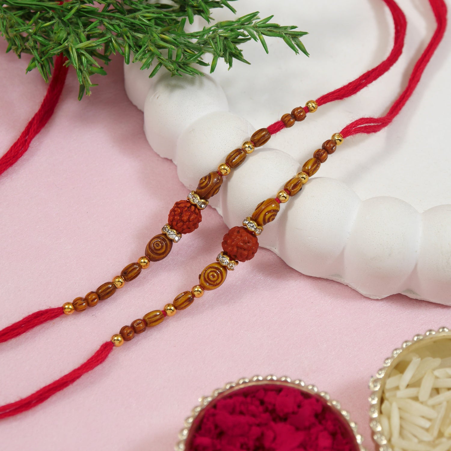 Rudraksh Rakhis are crafted with rudraksha beads and red thread.