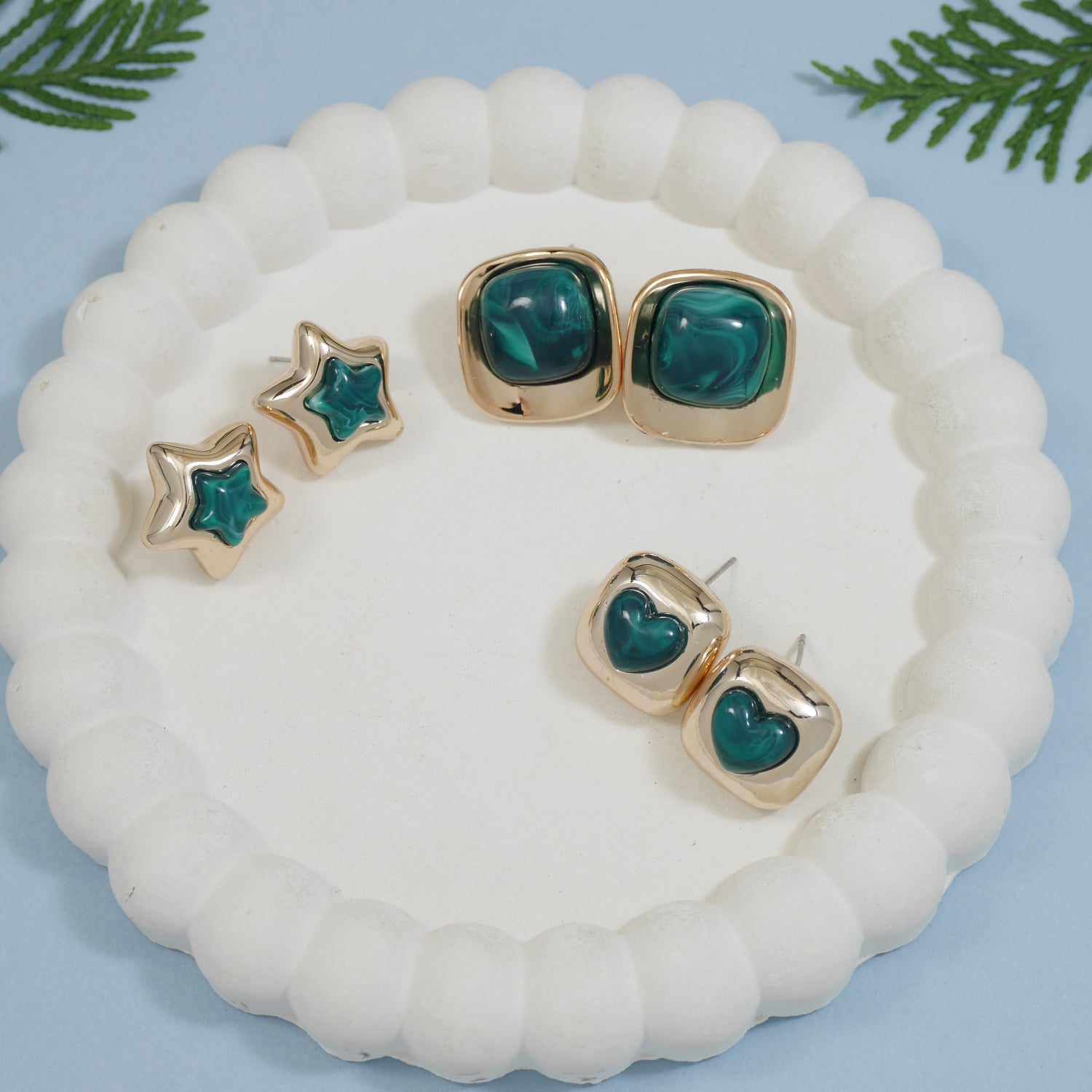 Set of three enamel stud earrings in green and gold-tone finish, featuring heart, star, and bold square designs