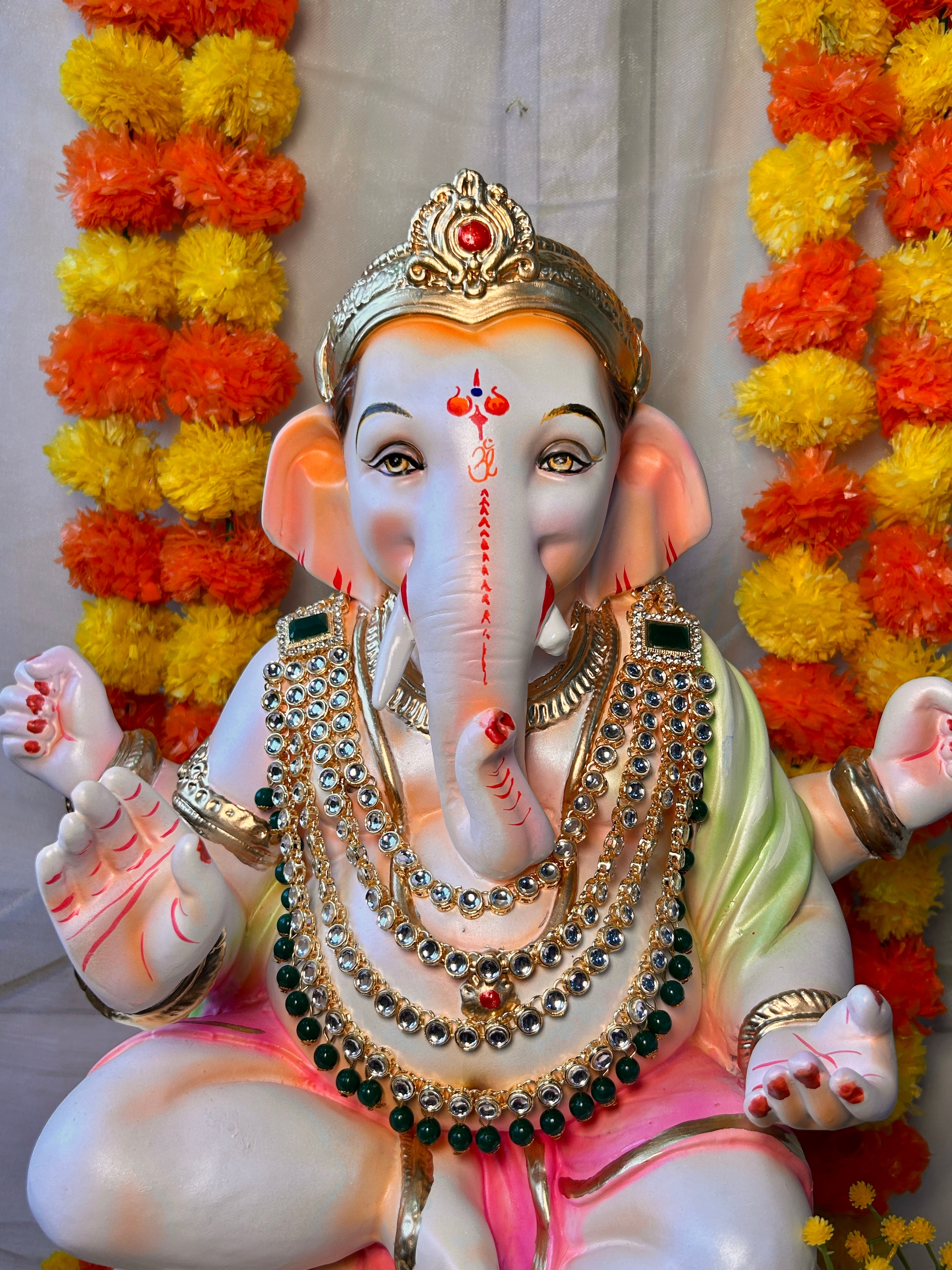 Red and white bead mala for Ganpati Bappa decoration during festivals.