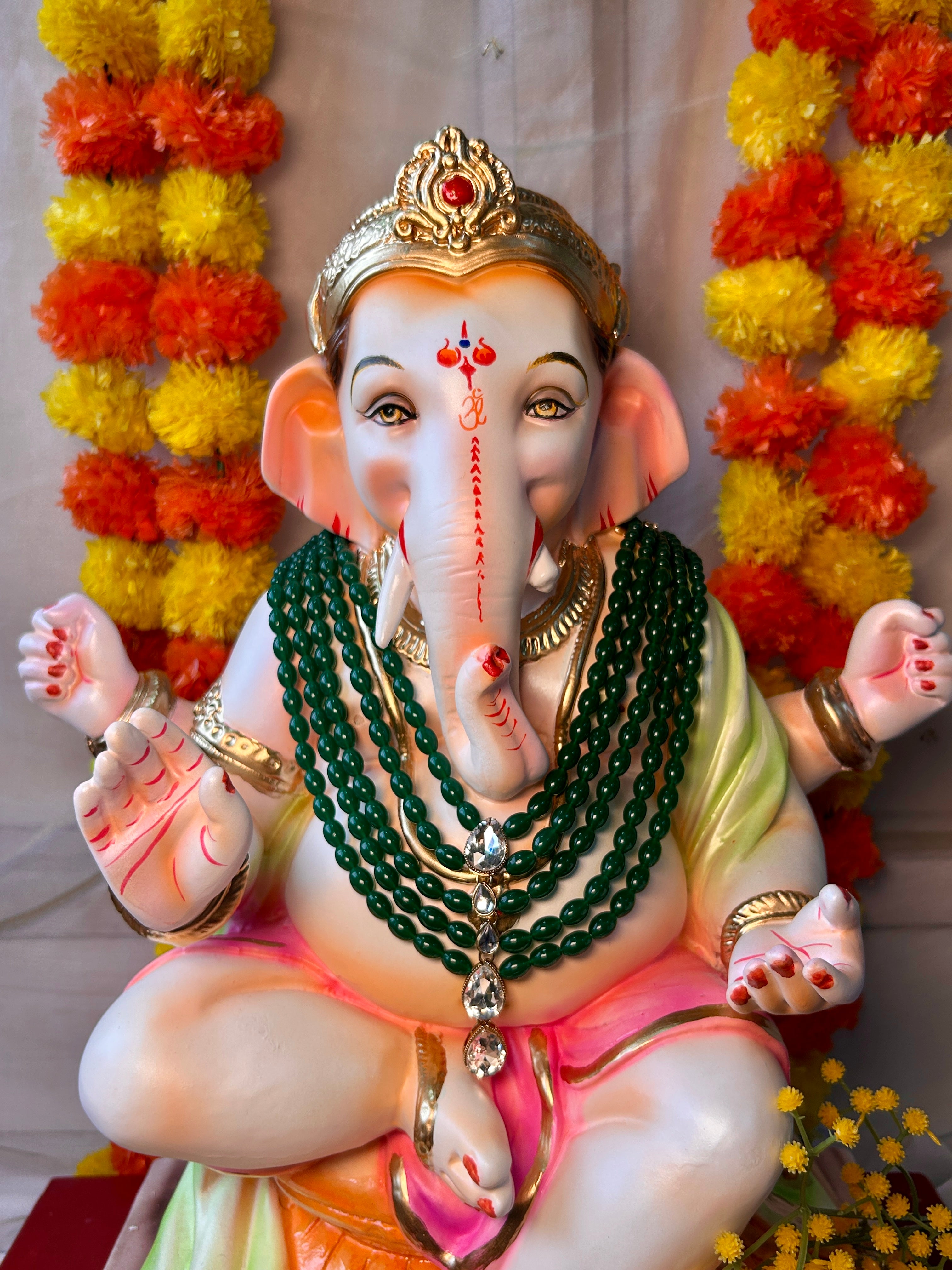 Green kundan and pearl Ganpati mala for murti decoration and festive worship.

