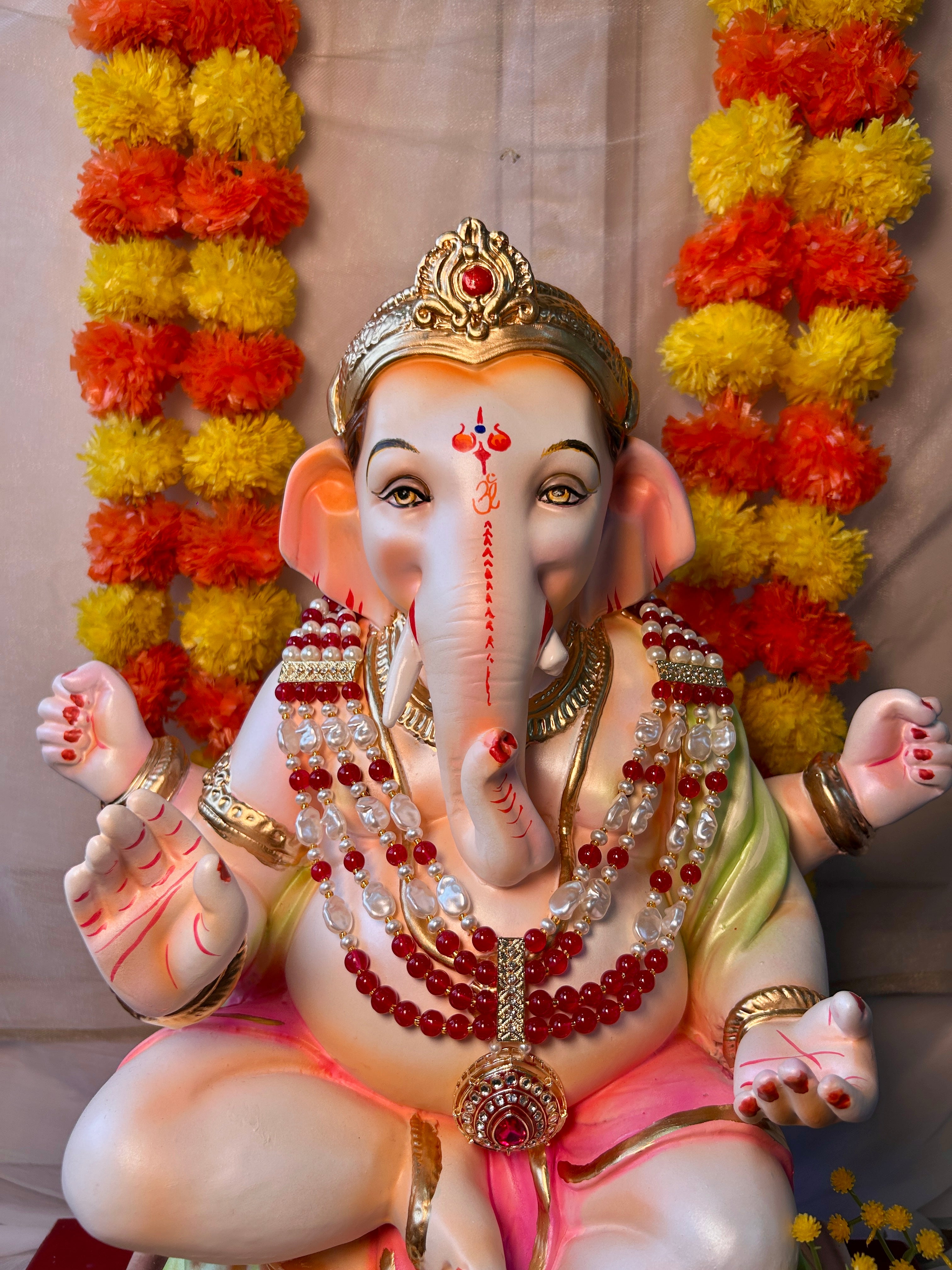 Handcrafted pink kundan Ganpati mala with vibrant beads for Ganesh idol decoration and festive pooja decor.

