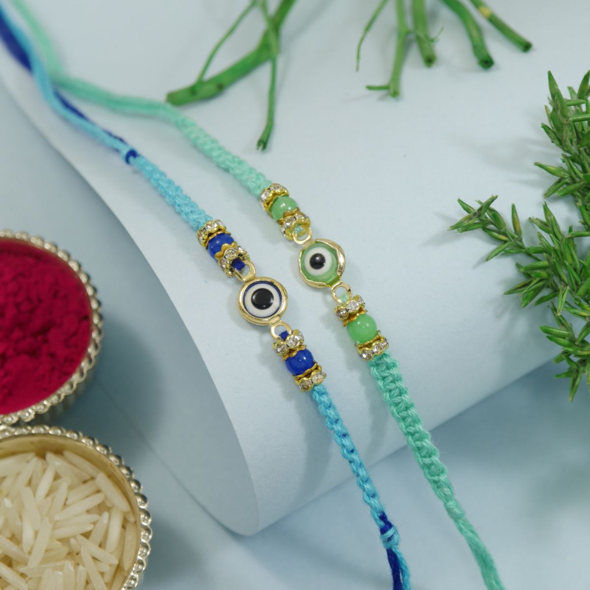 Minimalist Evil Eye Rakhis With Roli Chawal & Rakshabandhan Card (Pack of 2)