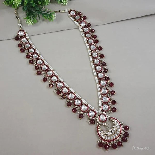 Long maroon kundan Ganpati mala with bead drops and crescent moon pendant.

