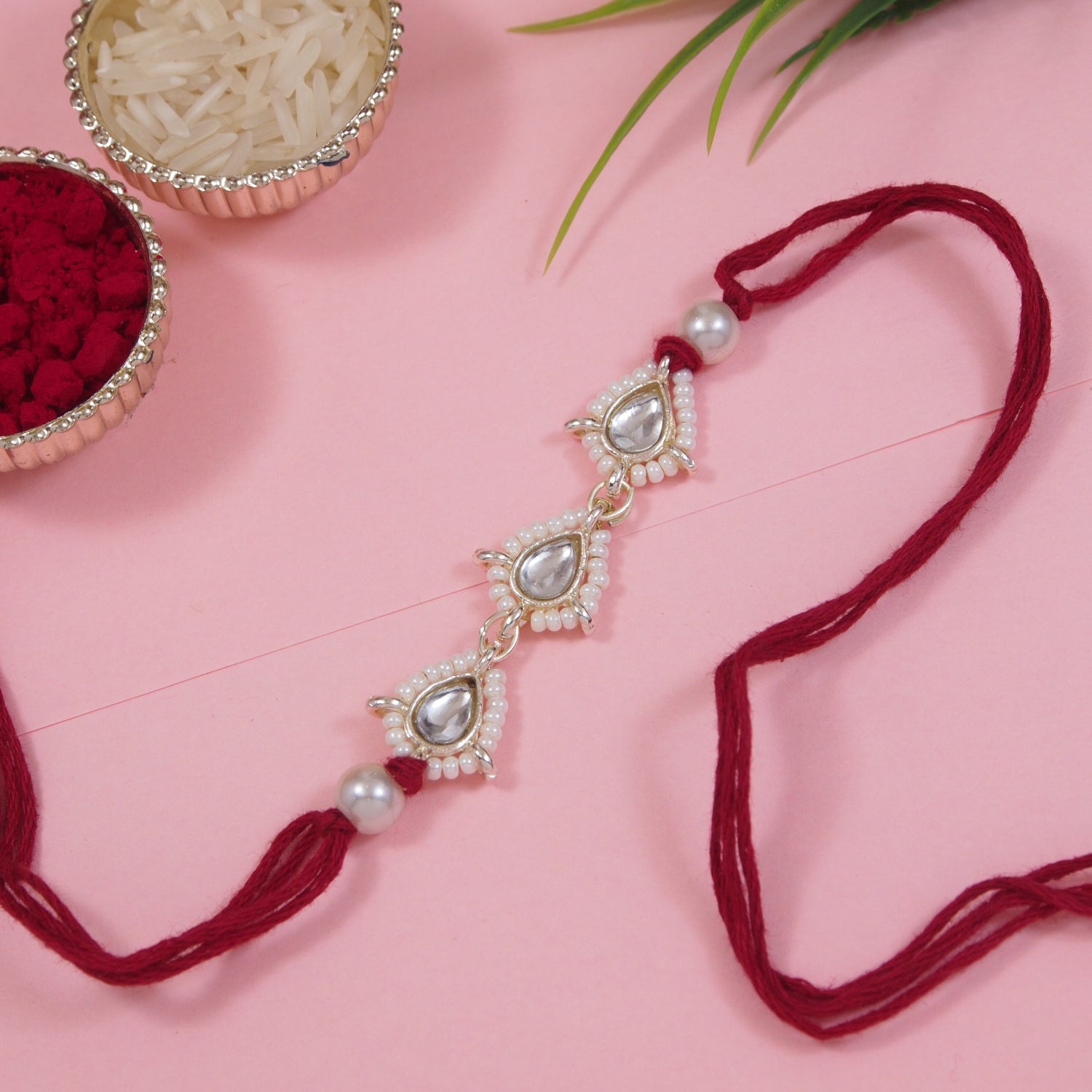 Delicate Pearl Beads Maroon Rakhi with Roli Chawal & Rakshabandhan Card