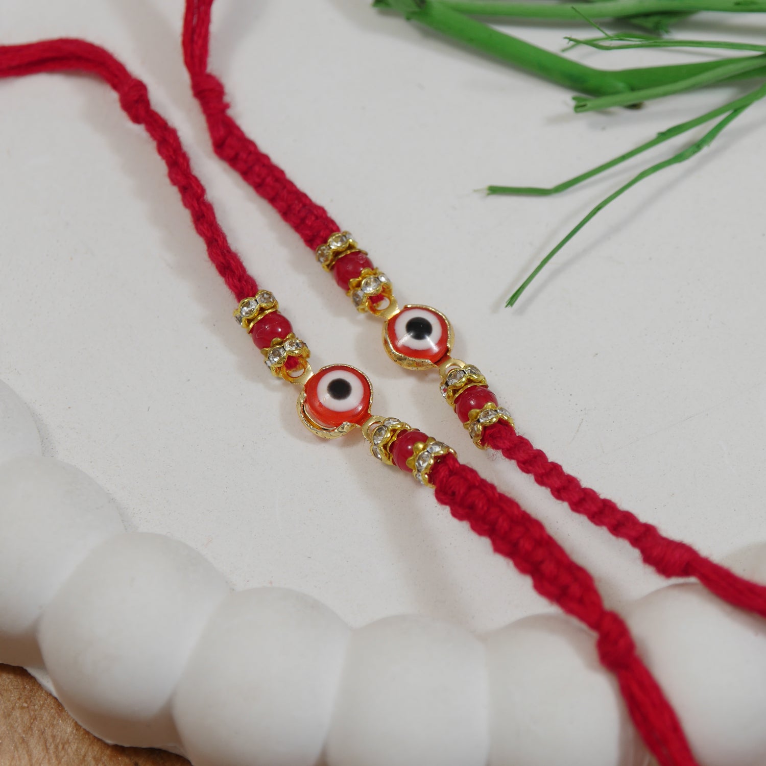 Minimalist Evil Eye Rakhis With Roli Chawal & Rakshabandhan Card (Pack of 2)