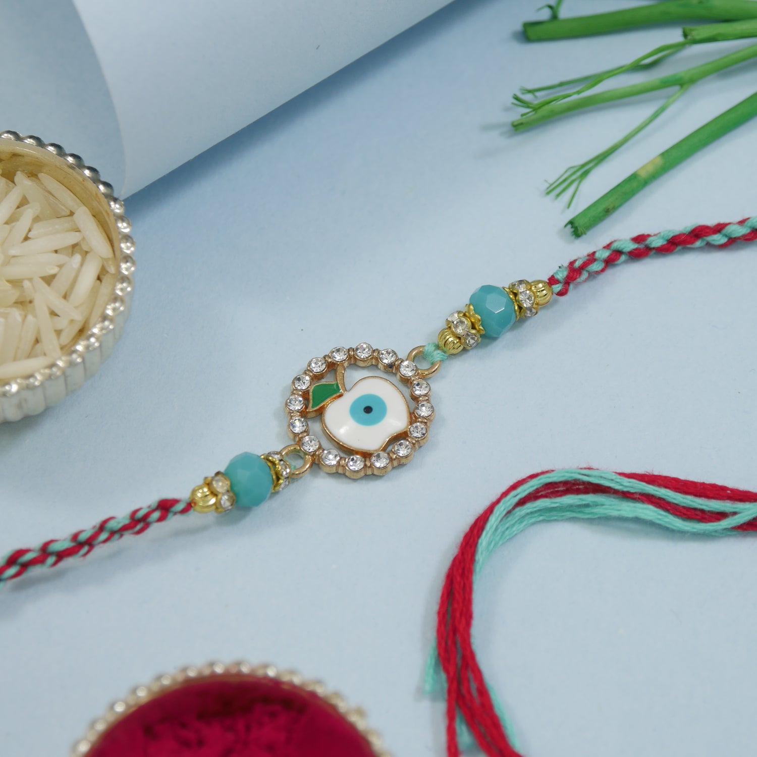 Apple Evil Eye Rakhi With Roli Chawal & Rakshabandhan Card
