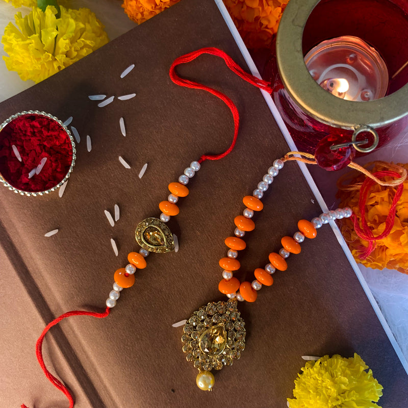 Yellow Gold Plated Pearl and Stone Studded Rakhi for Bhaiya and Bhabhi